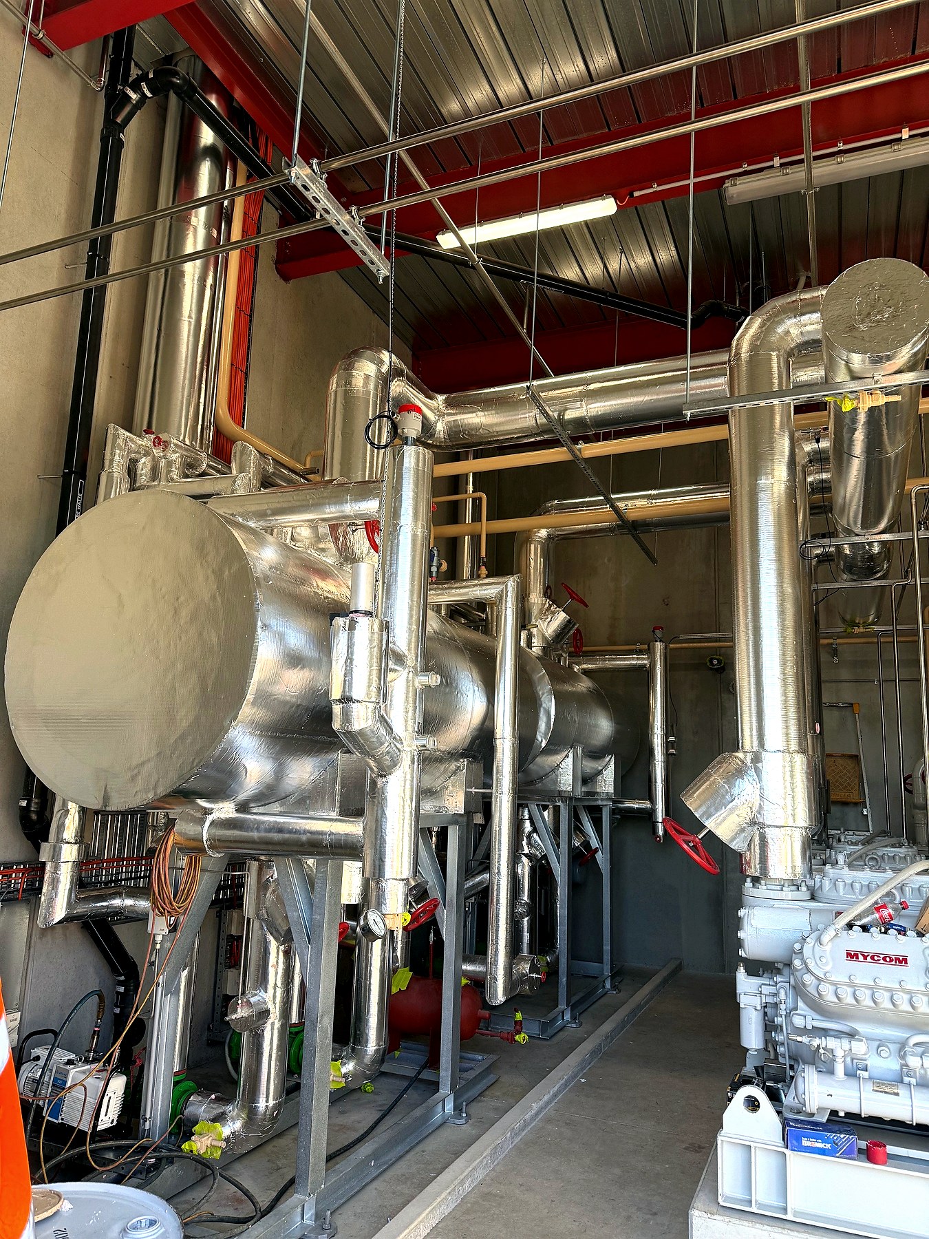 Foil-faced thermal insulation on process vessels and pipework on a factory-built skid unit